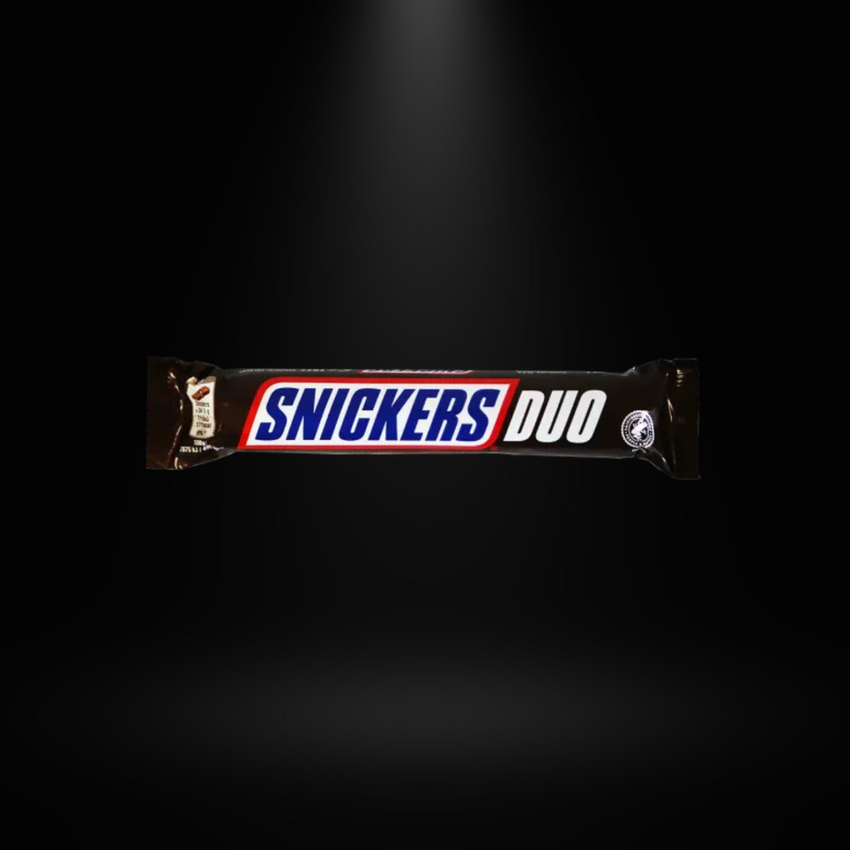 Snickers Duo 84gm on black background with overhead spotlight