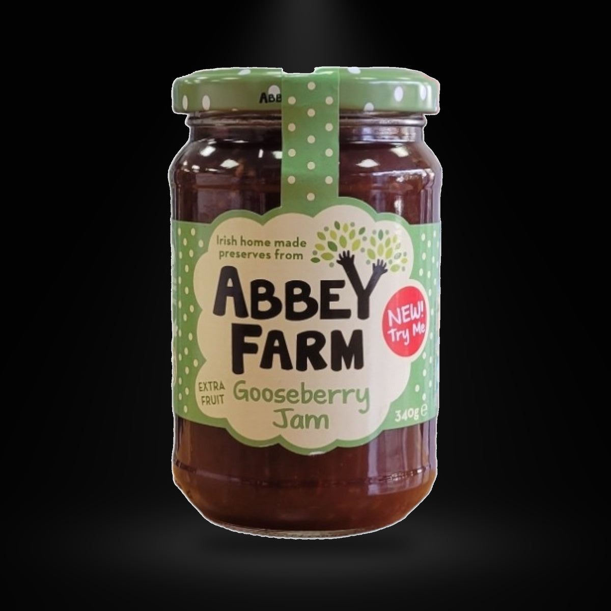 Abbey Farm Gooseberry Jam on a black background with an overhead spotlight