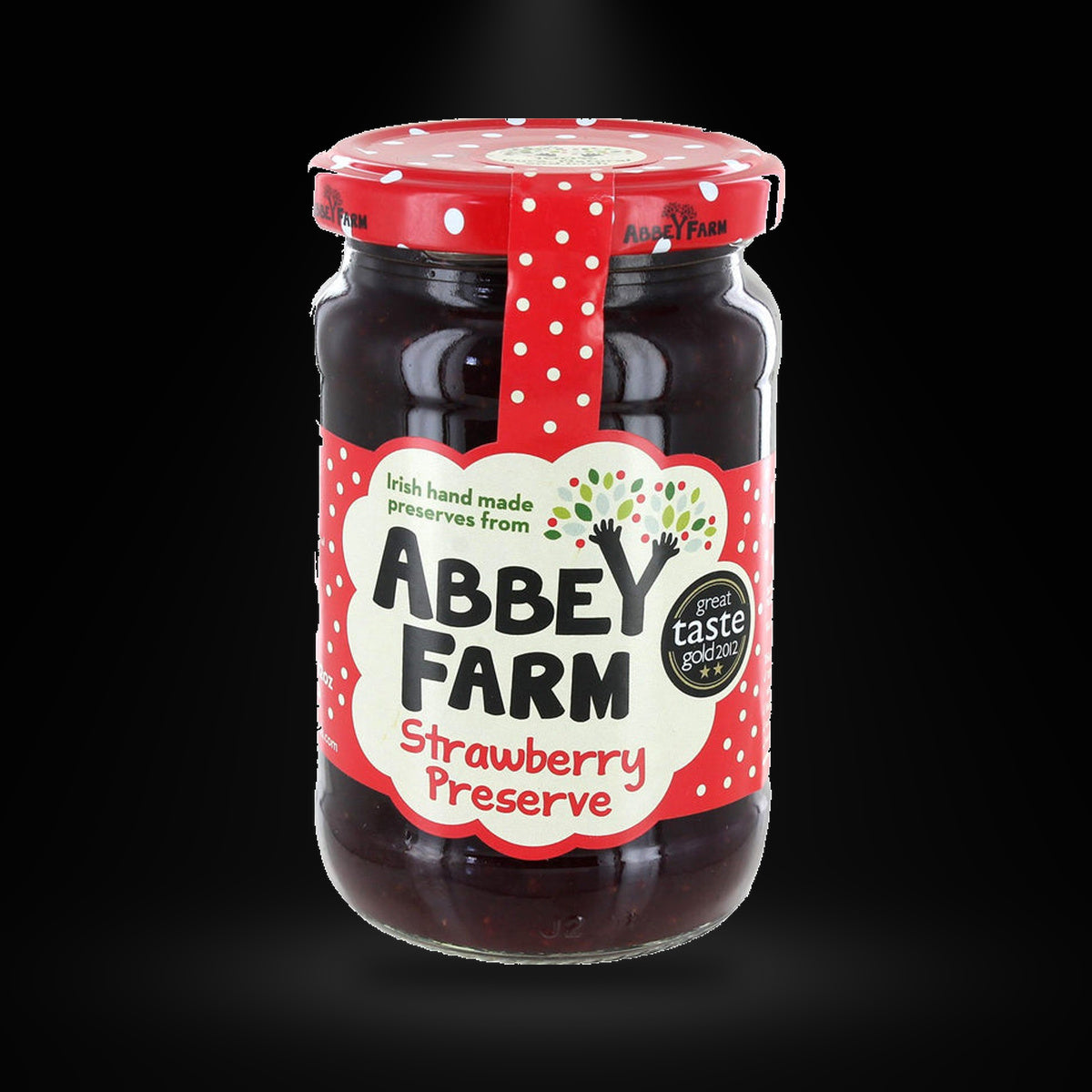 Abbey Farm Strawberry Jam on a black background with an overhead spotlight