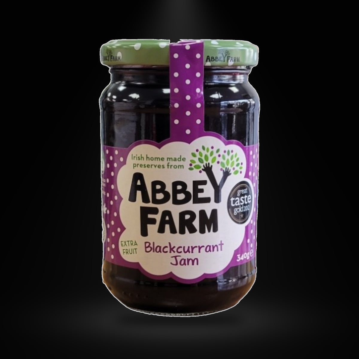 Abbeyfarm Blackcurrant Jam 350G on a black background with an overhead spotlight