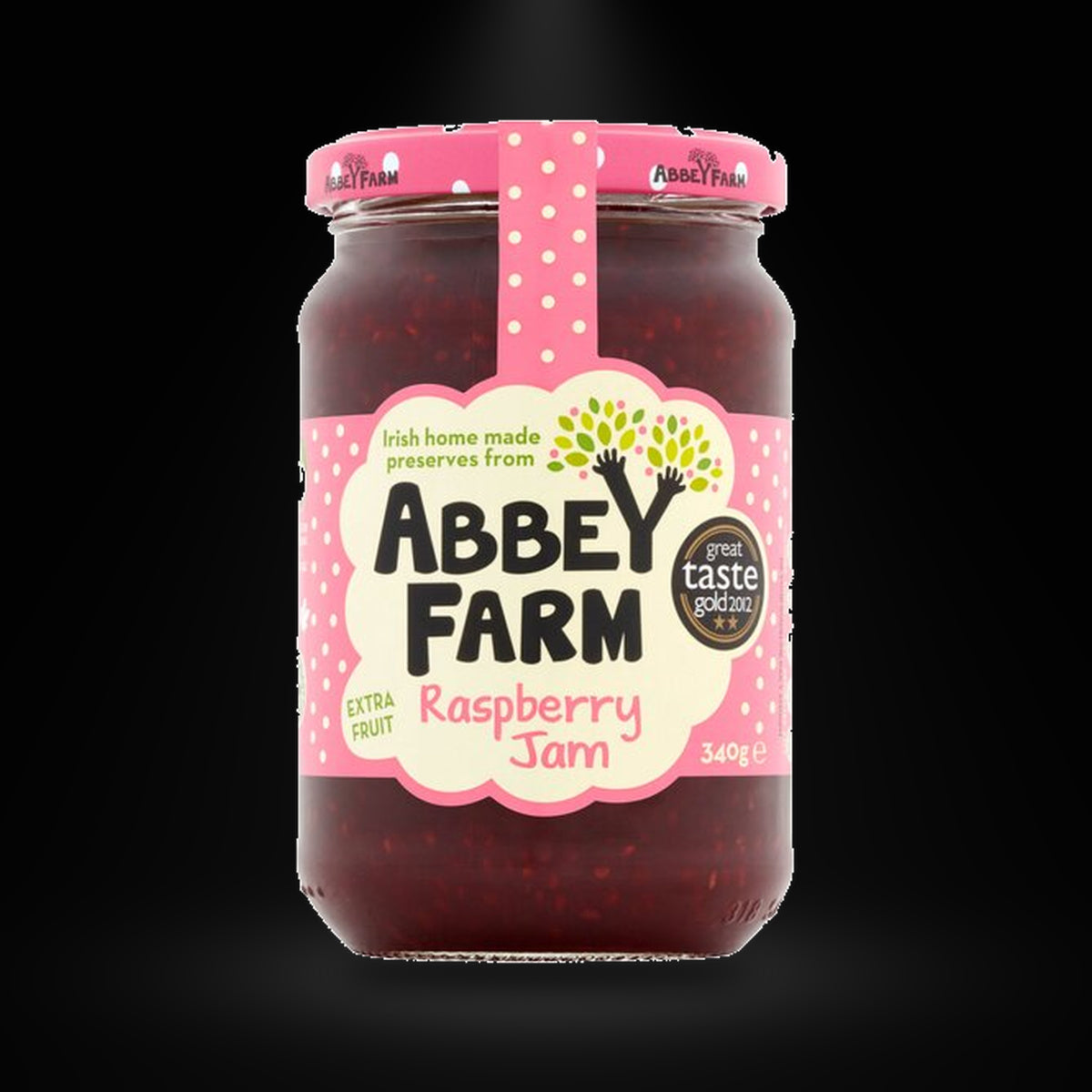 Abbey Farm Raspberry Jam on a black background with an overhead spotlight