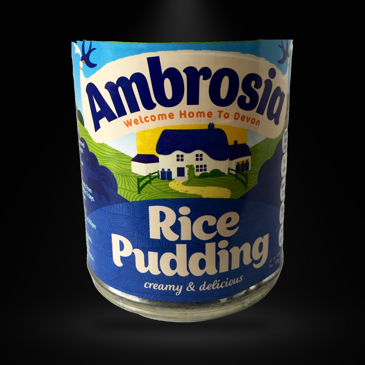 Ambrosia Rice Pudding 400gm on a black background with an overhead spotlight