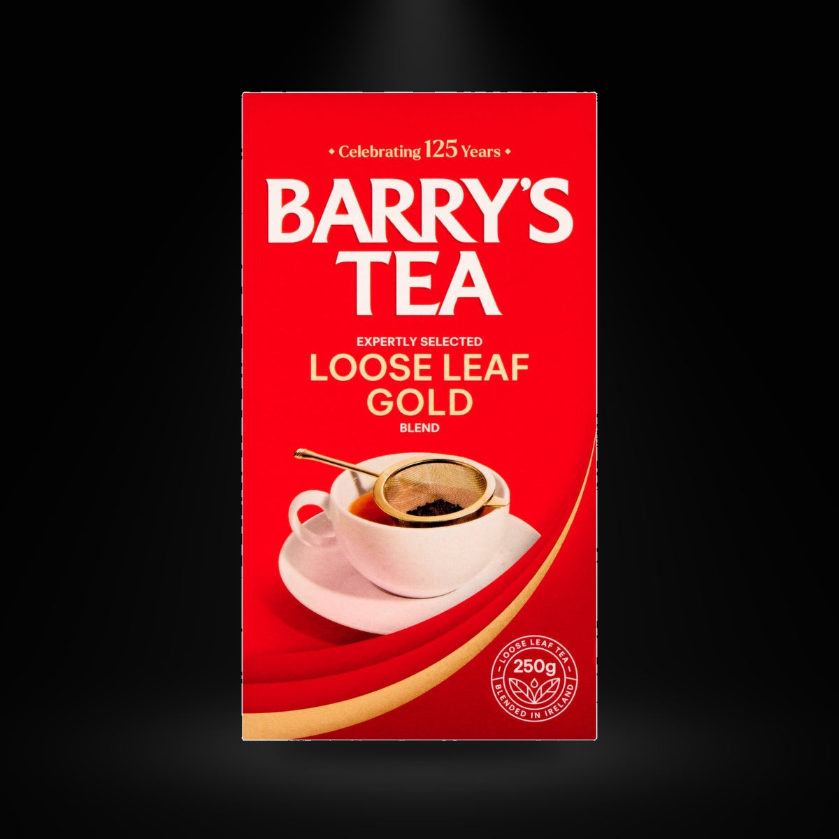 Barry's Gold Blend Loose Leaf Tea 250g on a black background with an overhead spotlight