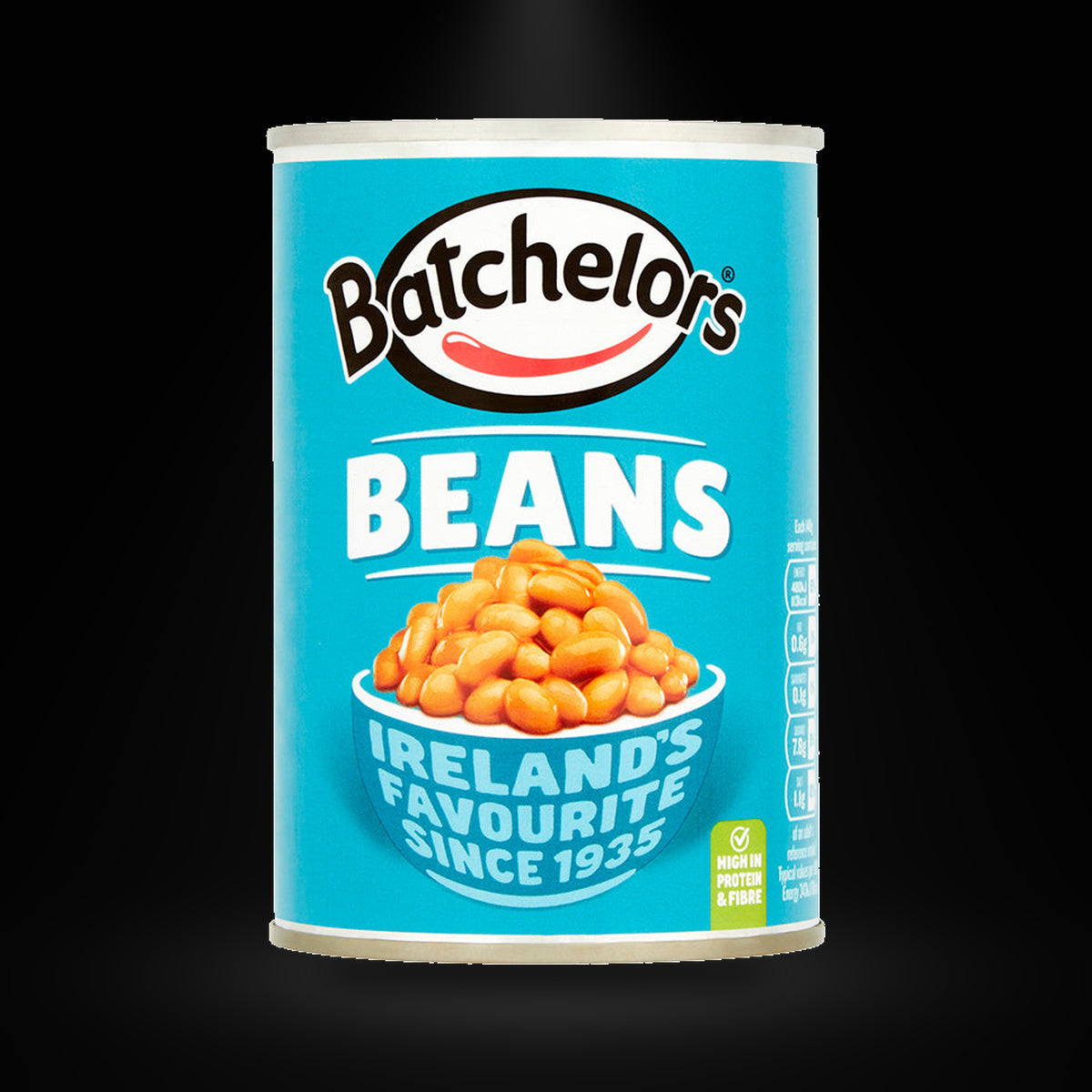 Batchelors baked Beans on a black background with an overhead spotlight