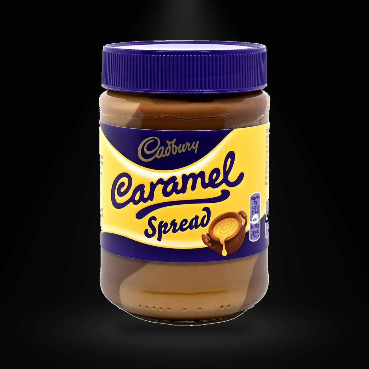 Cadbury Caramel Spread on a black background with an overhead spotlight