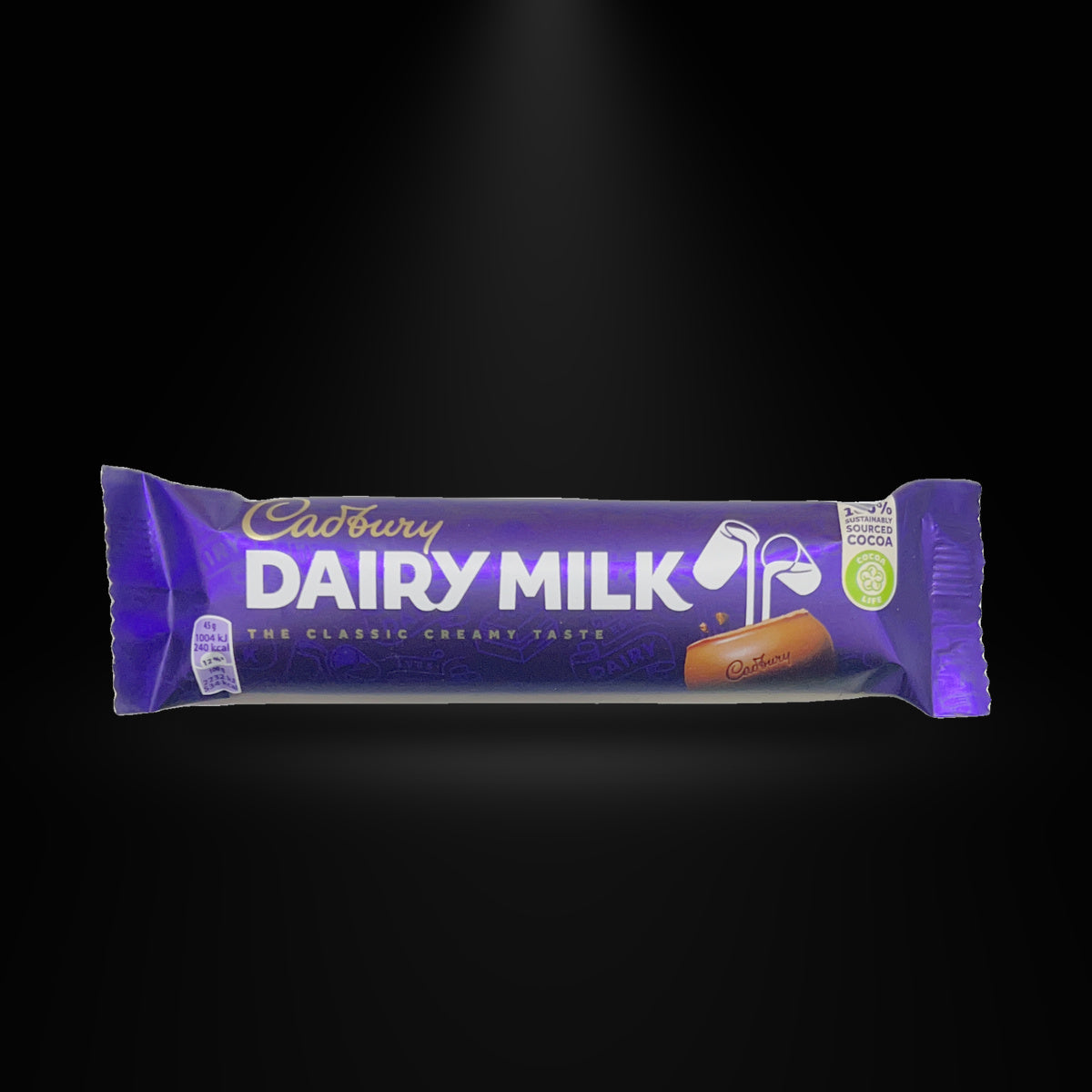 Cadbury Dairy Milk 1.58 Oz on a black background with an overhead spotlight