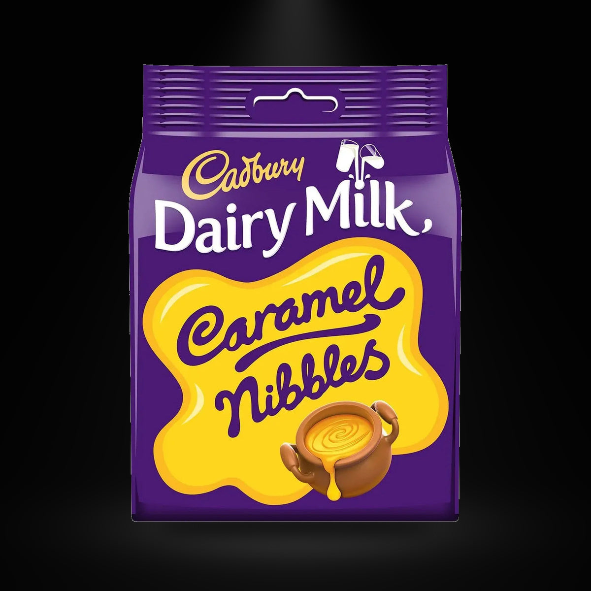 Cadbury Dairy Milk Caramel Nibbles 100g on a black background with an overhead spotlight