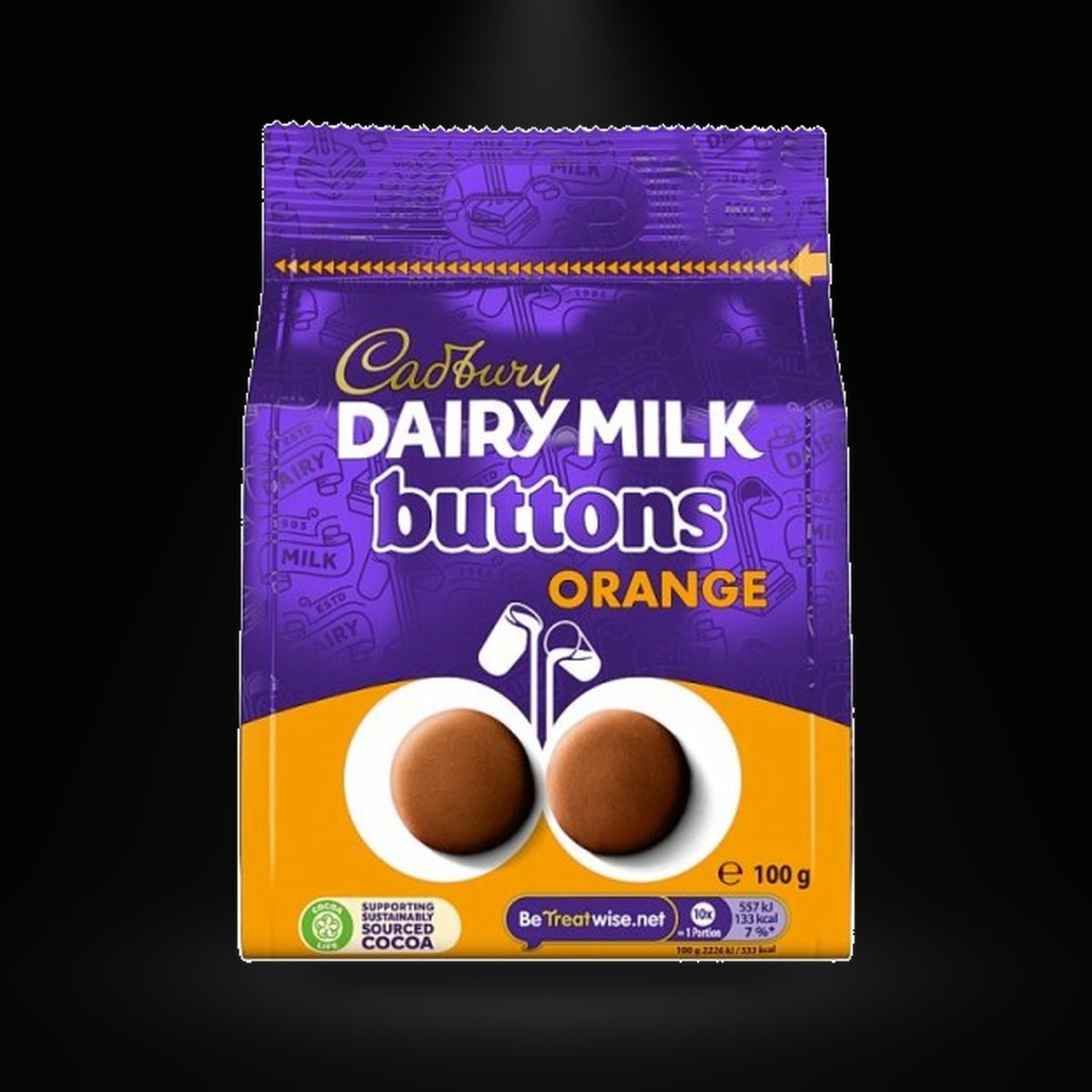 Cadbury Giant Buttons Orange Pouch 100g on a black background with an overhead spotlight