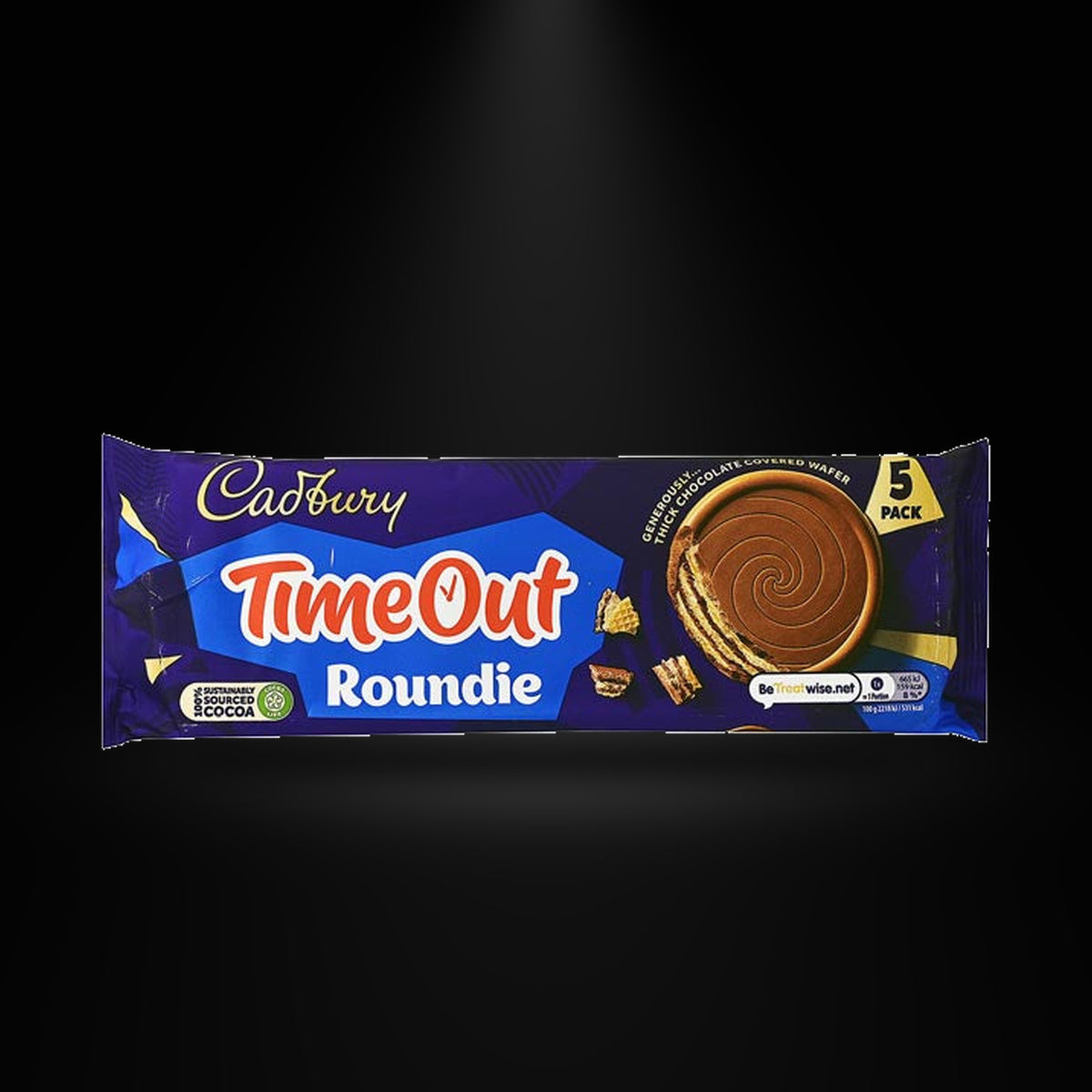 Cadbury timeout roundie wafers on a black background with an overhead spotlight