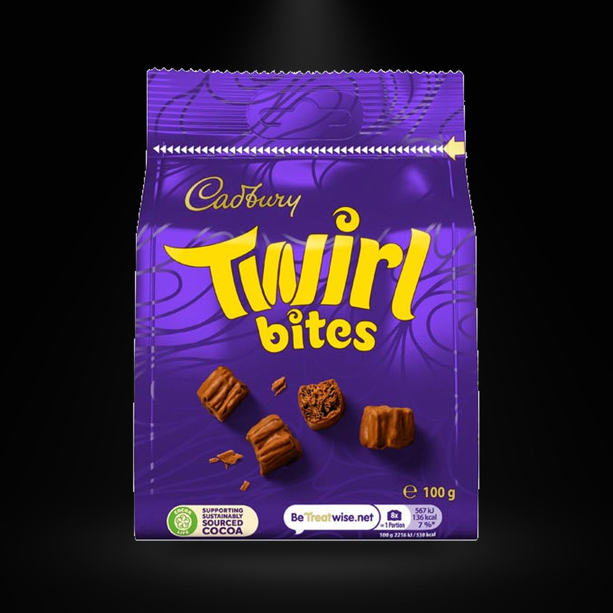 Cadbury Twirl Bites 100g on a black background with an overhead spotlight