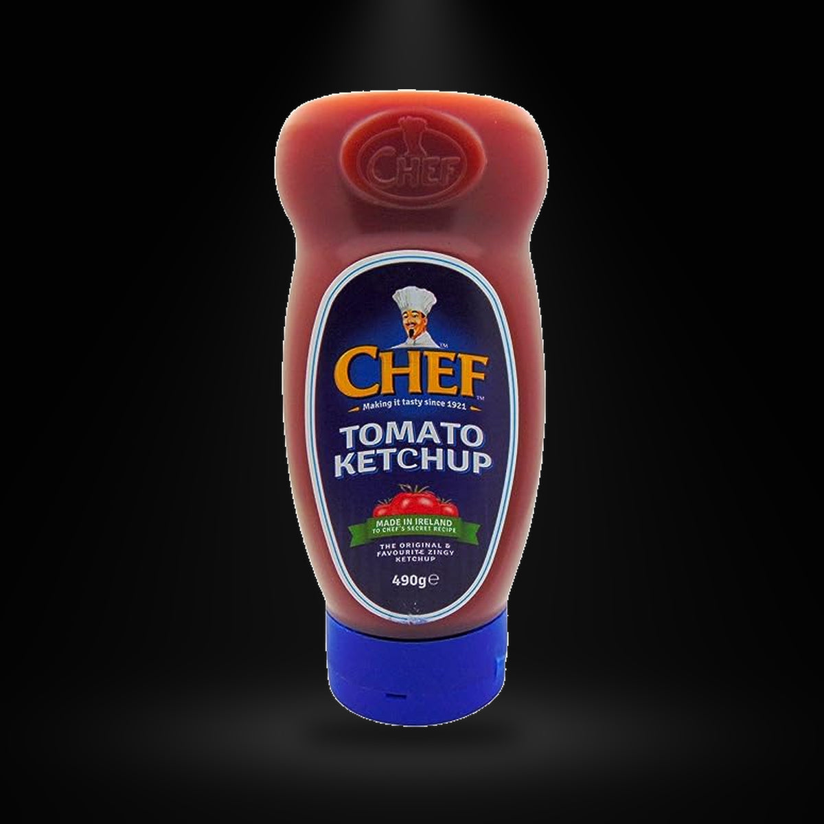 Chef Ketchup 490gm on a black background with an overhead spotlight