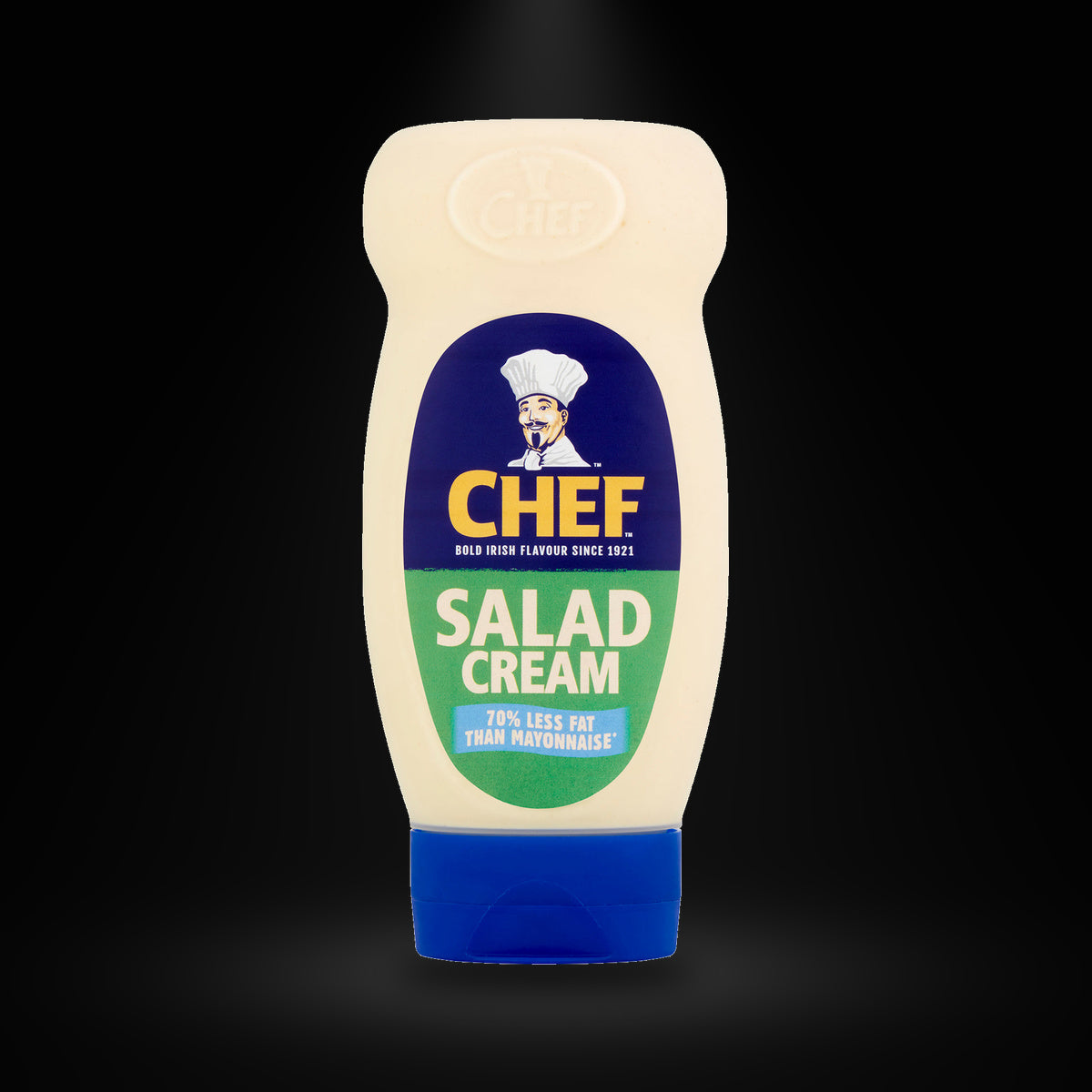 Chef salad cream squeezy on a black background with an overhead spotlight