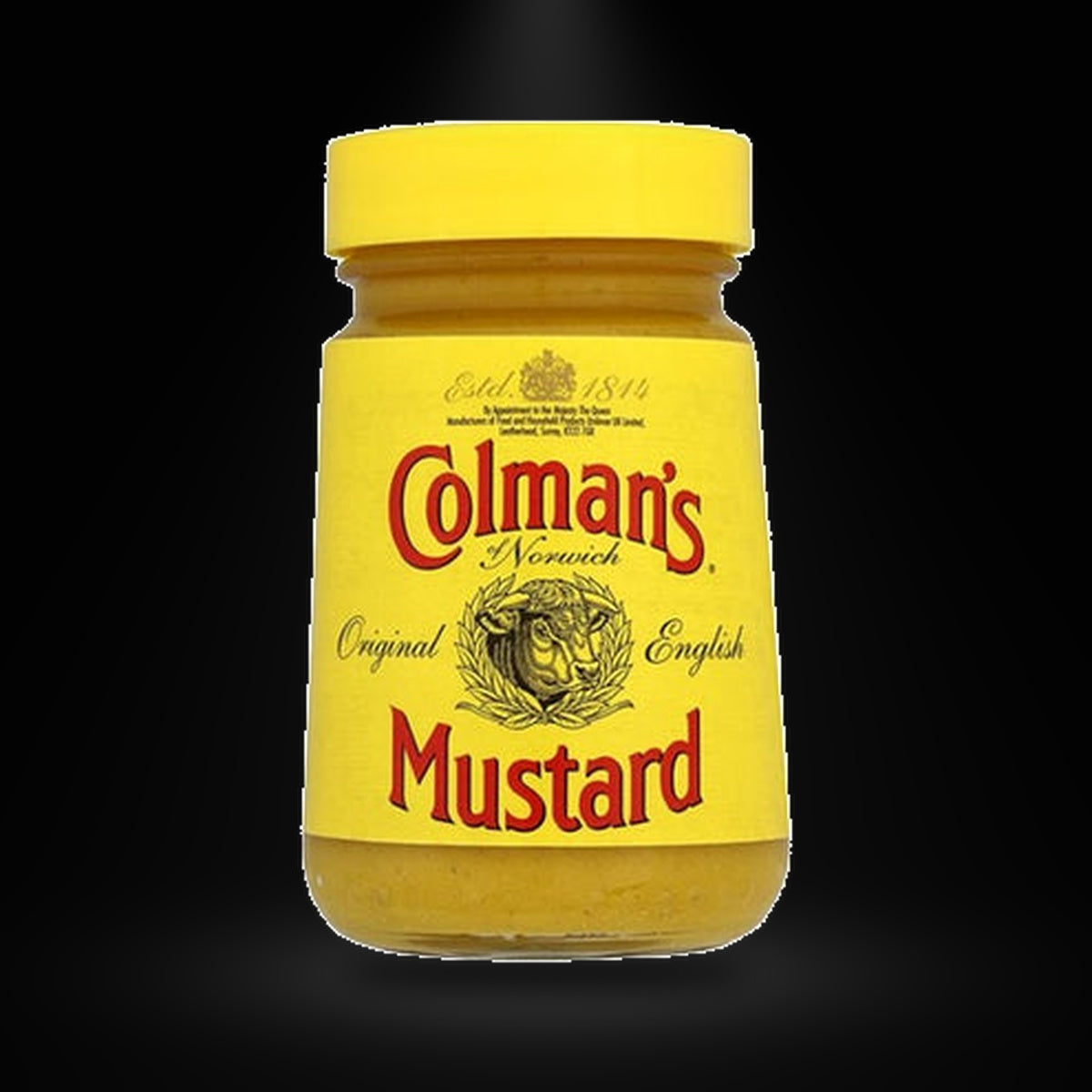 Colmans Mustard 100g on a black background with an overhead spotlight