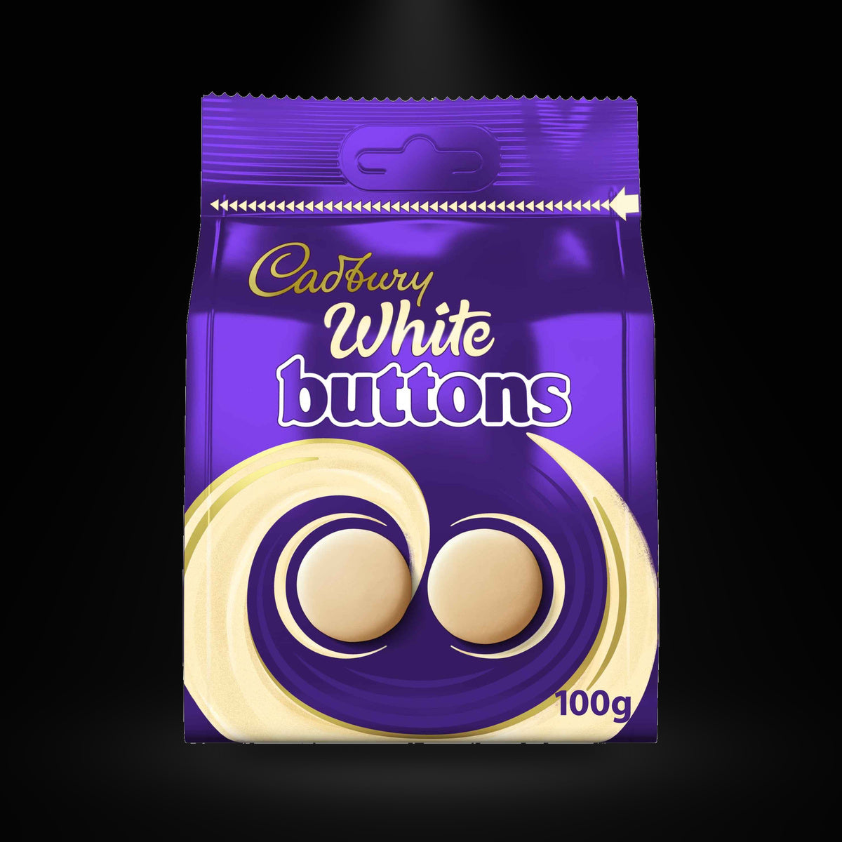 Dairymilk white buttons on a black background with an overhead spotlight