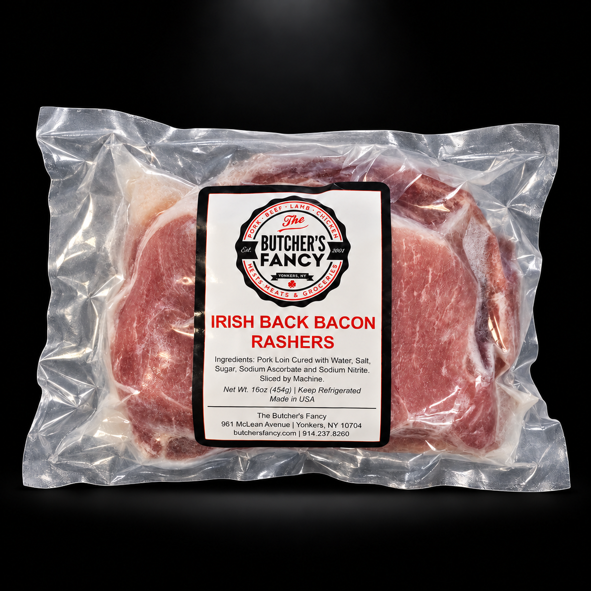 Butcher's Fancy Irish Back Becon Rashers — black background with overhead spotlight