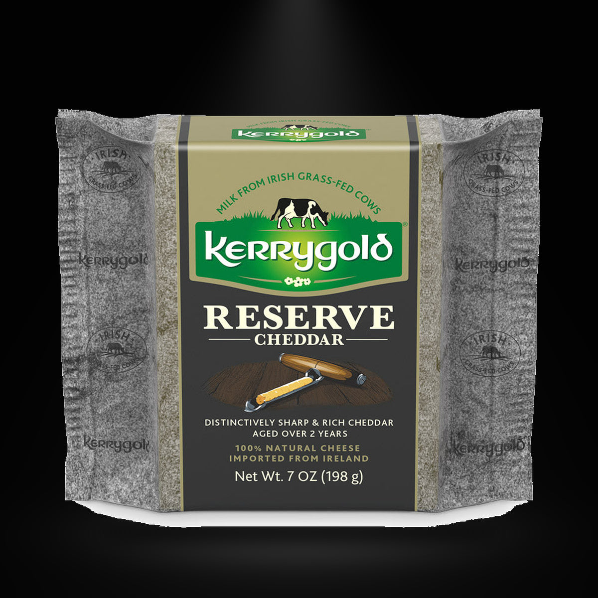 Kerry Gold Reserve Cheddar Cheese on a black background with an overhead spotlight