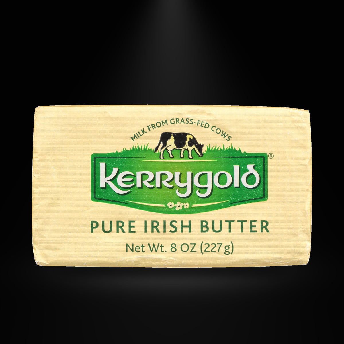 Kerrygold Salted Irish Butter 227gm on a black background with an overhead spotlight