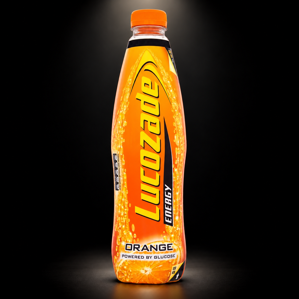 Lucozade energy org 900ml on black background with overhead spotlight