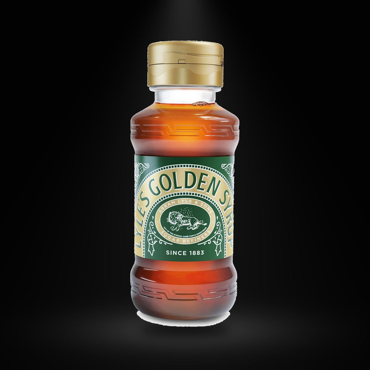 Lyle's Golden Syrup 325 gm on a black background with an overhead spotlight