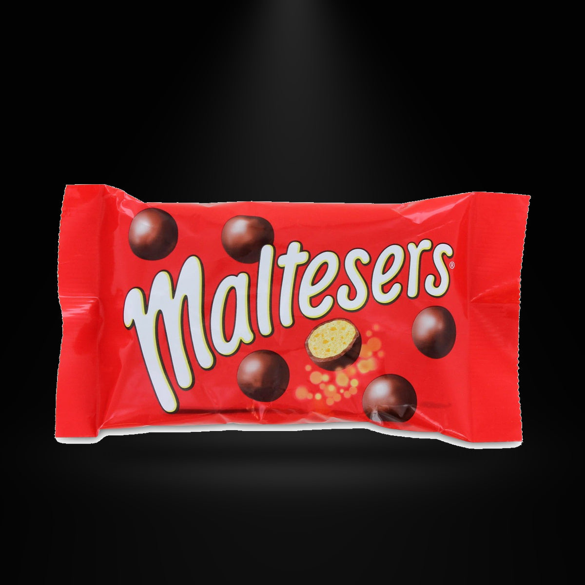 Mars 37g Maltesers on a black background with an overhead spotlight