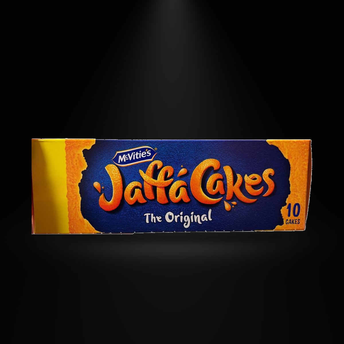 McVities Jaffa Cakes 106gm on a black background with an overhead spotlight