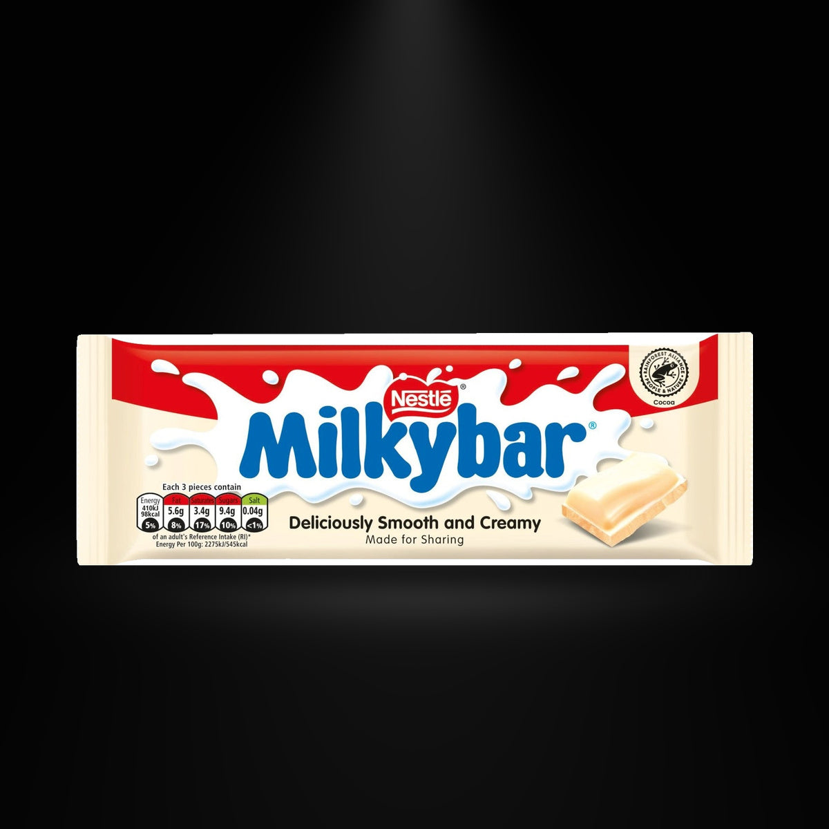 Milkybar 90gm on a black background with an overhead spotlight