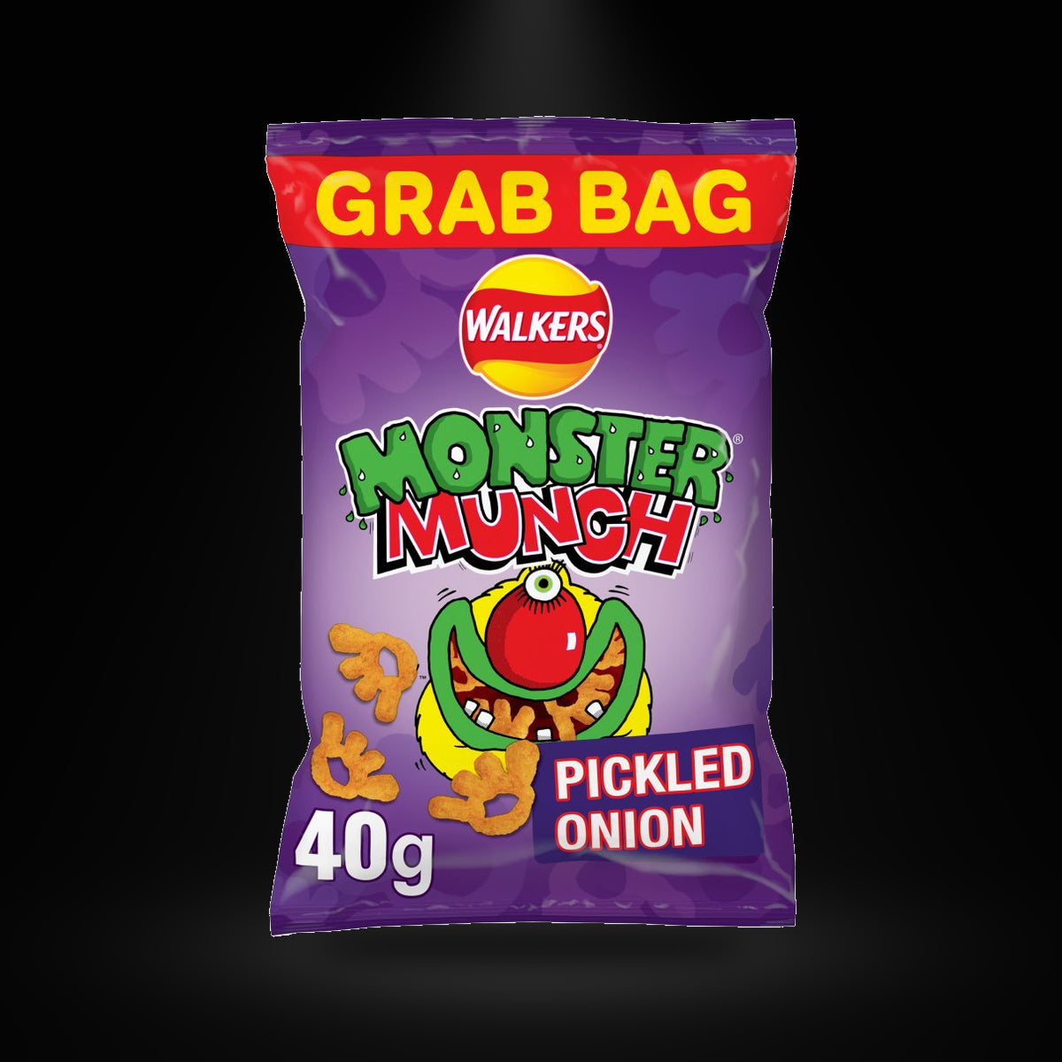 Monster munch Pickled Onion on a black background with an overhead spotlight