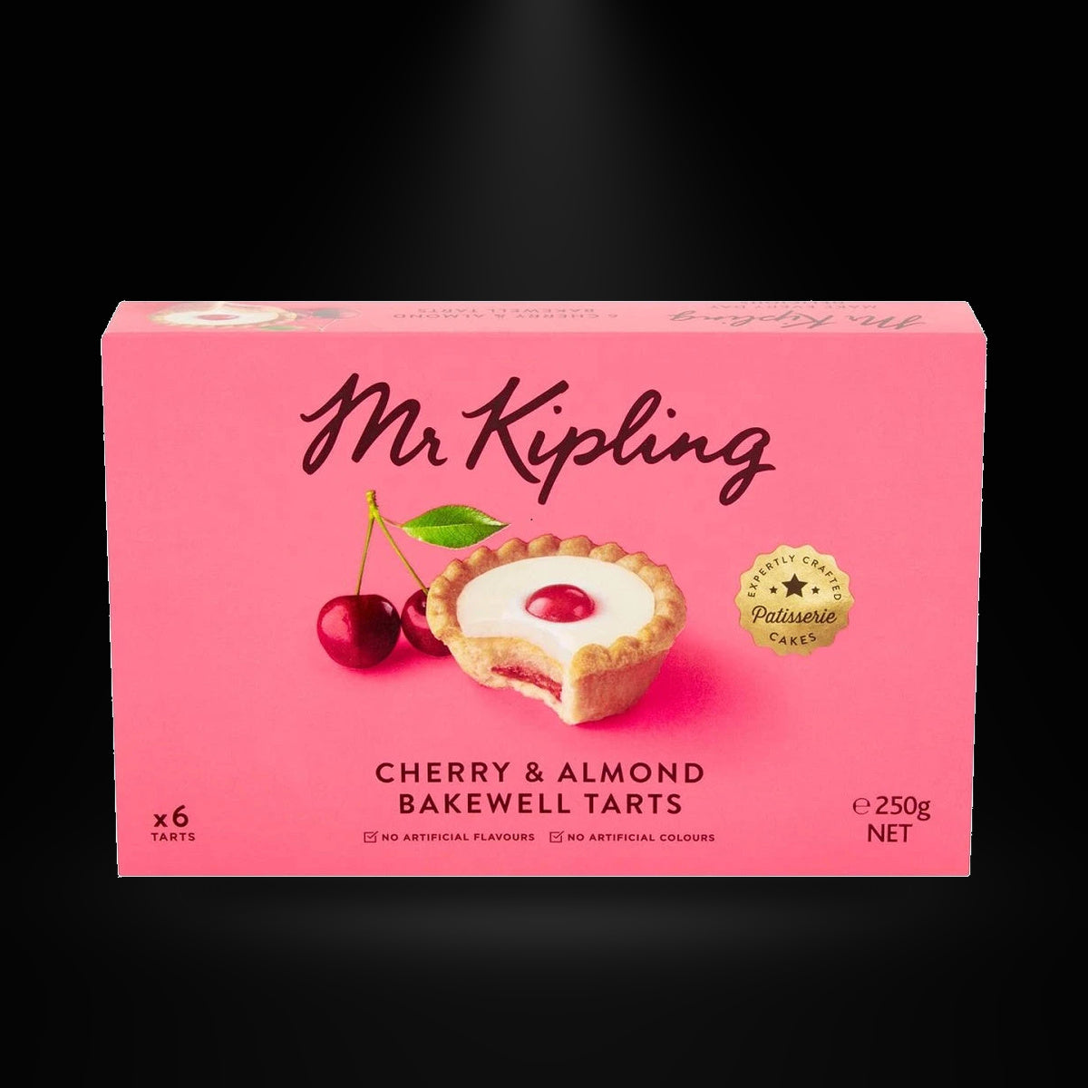 Mr Kipling Cherry and Almond Tarts on a black background with an overhead spotlight