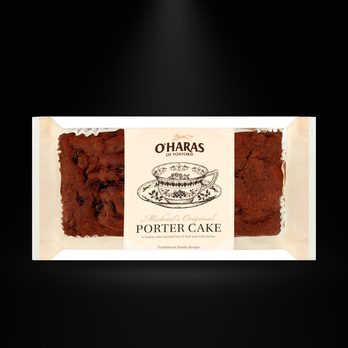 Ohara porter cake on a black background with an overhead spotlight