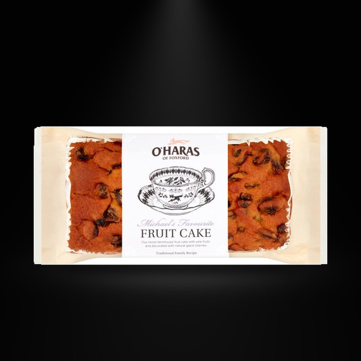 Oharas Fruit cake on a black background with an overhead spotlight