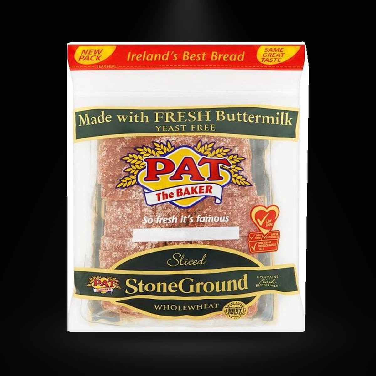 Pat stoneground bread on a black background with an overhead spotlight
