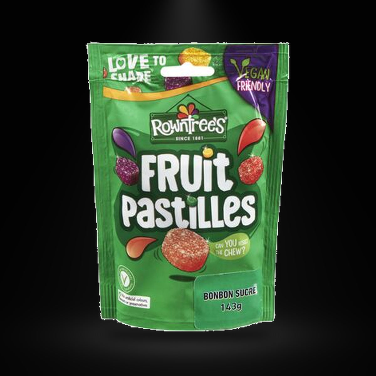 Rowntrees Fruit pastilles on a black background with an overhead spotlight