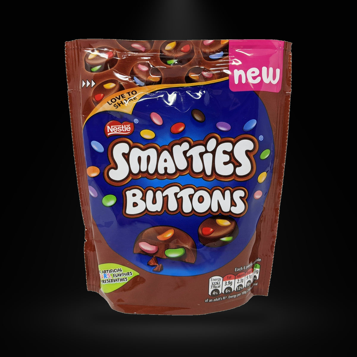 Smarties buttons pouch 90g on a black background with an overhead spotlight