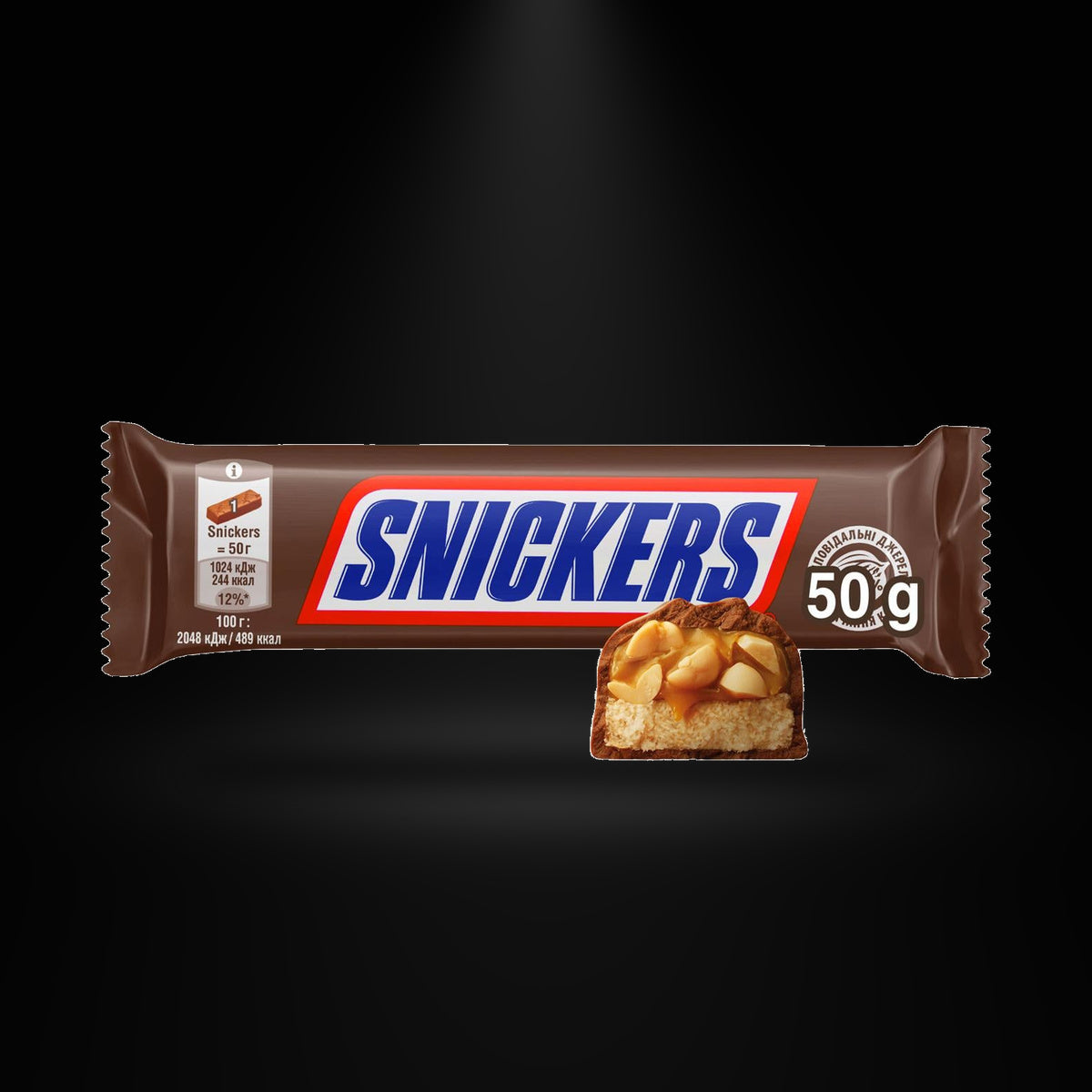 Snickers 50g on a black background with an overhead spotlight