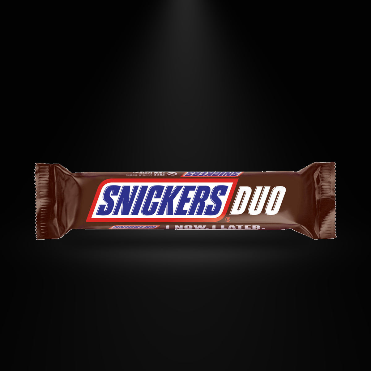 Snickers Duo 69g on a black background with an overhead spotlight