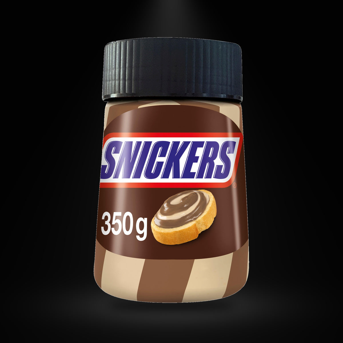 Snickers Spread 350G on a black background with an overhead spotlight
